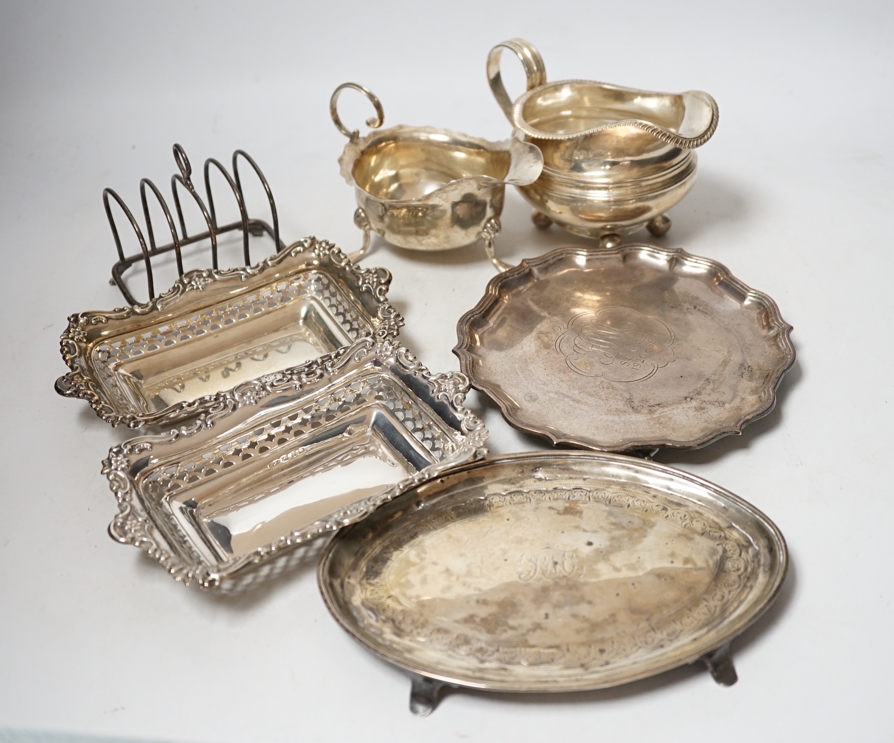 Sundry silver items including a Georgian cream jug, pair of later pierced bonbon dishes, Georgian teapot stand (a.f.), waiter, sauce boat and toastrack, 20.8oz.